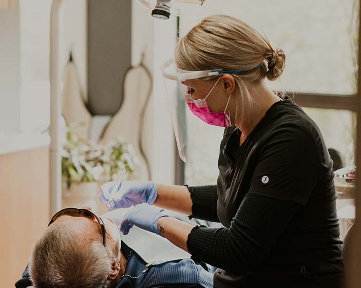 Hygienist working with patient